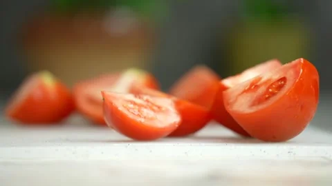 Sliced tomatoes, close-up. Man's hand with a knife cuts tomatoes Stock Footage 246382323