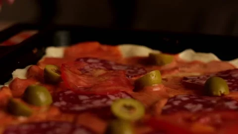 Sliced tomatoes falling down on homemade pizza Stock Footage 157055675