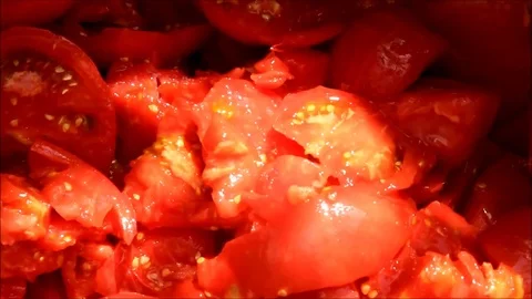 Sliced tomatoes falling into a pile of chopped tomatoes Stock Footage 77862464