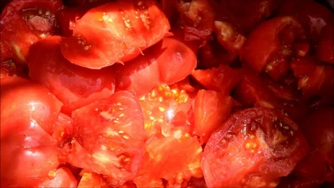 Sliced tomatoes falling into a pile of chopped tomatoes Stock Footage 77862726