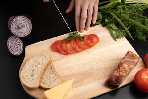 Sliced tomatoes on a kitchen board Stock Photos