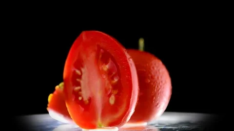 Sliced tomatoes rotation on black background Video stock 8683447
