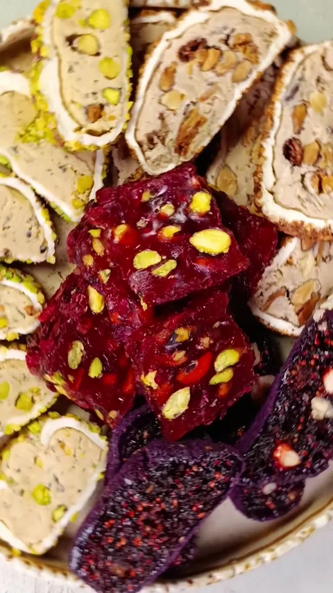Sliced ​​Turkish delight assortment rotating on the plate Stock Footage 311048078