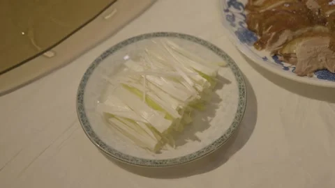 Sliced Vegetables and Cooked Meat Served on Plates in Beijing Restaurant Stock Footage 345769513