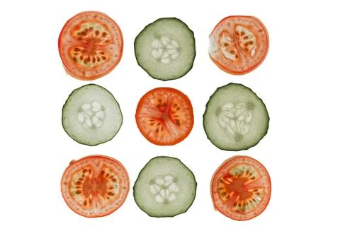 Sliced vegetables arranged in a grid pattern, bright red tomatoes with seeds, Stock Photos