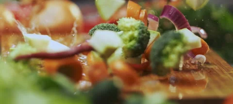 Sliced vegetables falling on table Video stock 311834755