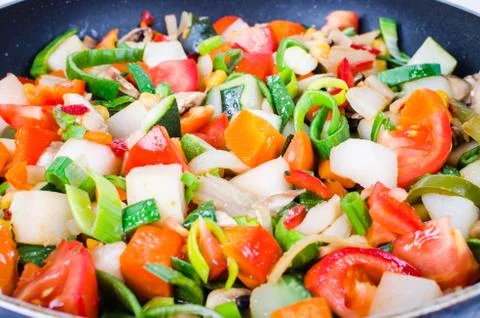 Sliced vegetables in the pan Stock Photos