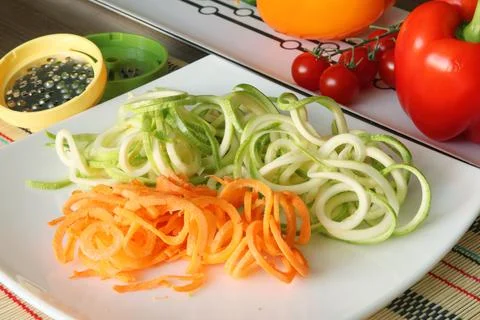 Sliced vegetables on plate on kitchen table. Healthy food. Stock Photos
