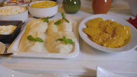 Sliced watermelon and mango on white plates with mint garnish Stock Footage 341419182