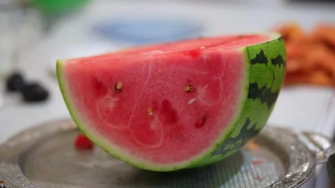 Sliced watermelon piece on a silver platter with background blur. Stock Footage 341562441
