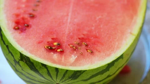 Sliced watermelon piece on a silver platter with background blur. Stock Footage 341562886