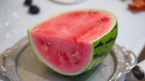 Sliced watermelon piece on a silver platter with background blur. Stock Footage 341562906