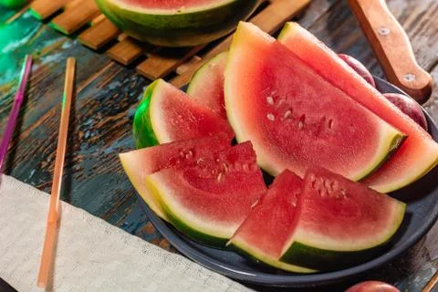 Sliced Watermelon on rustic background. Summertime concept. Stock Photos