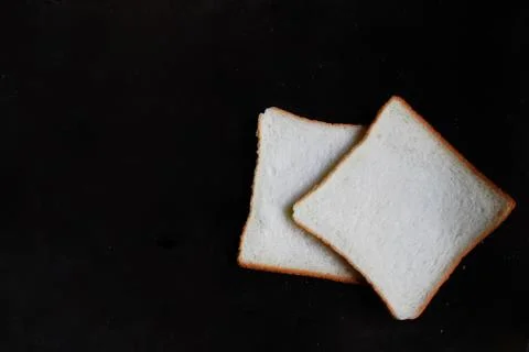 Sliced Wheat Bread on dark background Stock Photos