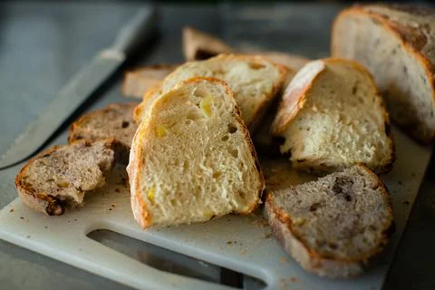 Sliced wheat bread on a plastic board Stock Photos