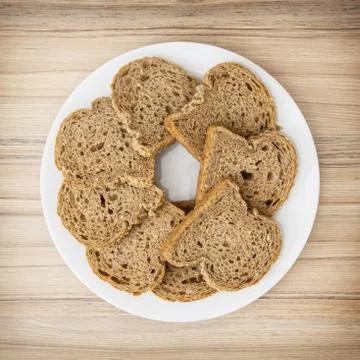 Sliced wheaten bread in circle shape on the white plate Stock Photos