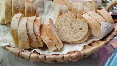Sliced white bread arranged in a woven basket with paper napkin, showcasing the Stock Footage 332961637