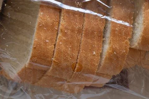 Sliced white bread in a clear plastic bread bag with an air vent. Food packag 스톡 사진