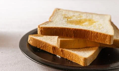 Sliced white bread on a desk. Close up. Bright mood. Horizontal. Suitable f.. Stock Photos