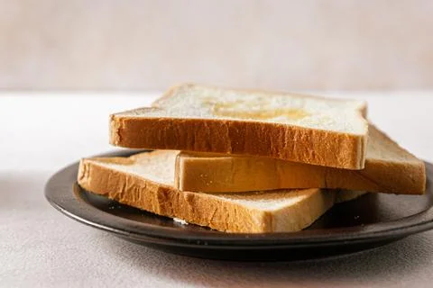 Sliced white bread on a desk. Close up. Bright mood. Horizontal. Suitable f.. Stock Photos