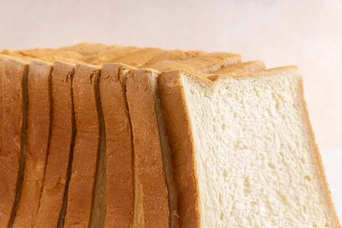 Sliced white bread on a desk. Close up. Bright mood. Horizontal. Suitable f.. Stock Photos