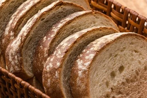 Sliced white bread with wheat flour on a wooden table. Chamado Po de forma Stock Photos