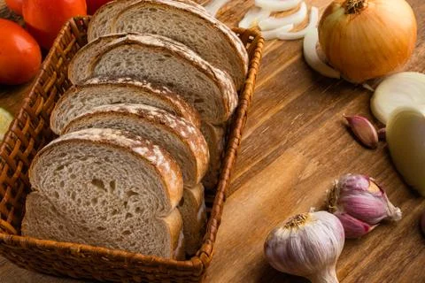 Sliced white bread with wheat flour on a wooden table. Chamado Po de forma Stock Photos