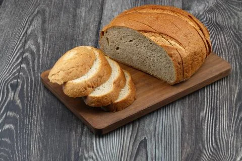 Sliced whole wheat bread isolated on wooden background Stock Photos