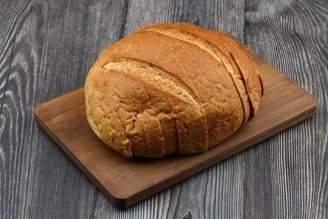 Sliced whole wheat bread isolated on wooden background Stock Photos