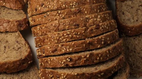 Sliced whole wheat bread with sesame seeds rotating Stock Footage 344603990
