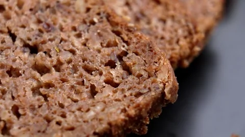 Sliced wholemeal rye German bread on black dish. Stock Footage 331803009