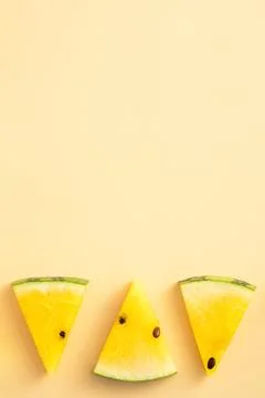 Sliced yellow watermelon pattern flat lay on pastel yellow table background. Foto stock