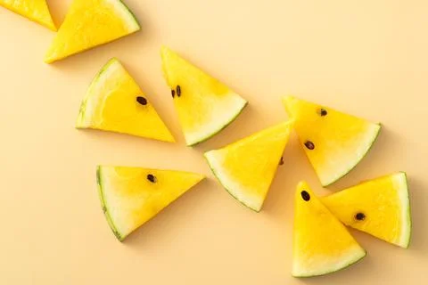 Sliced yellow watermelon pattern flat lay on pastel yellow table background. 스톡 사진