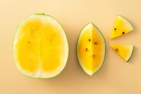 Sliced yellow watermelon pattern flat lay on pastel yellow table background. 写真素材