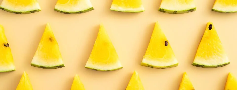 Sliced yellow watermelon pattern flat lay on pastel yellow table background. Stock Photos