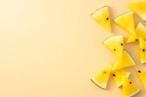 Sliced yellow watermelon pattern flat lay on pastel yellow table background. Stock Photos