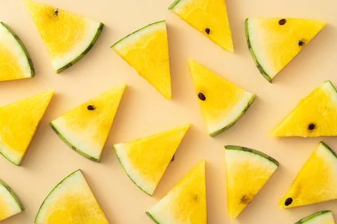 Sliced yellow watermelon pattern flat lay on pastel yellow table background. Stock Photos