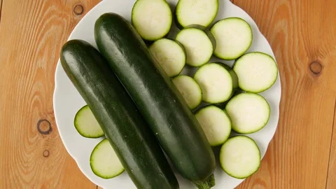 Sliced zucchini on a plate. Video stock 247426988