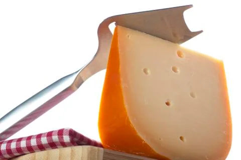 Slicer and cheese wedge Stock Photos