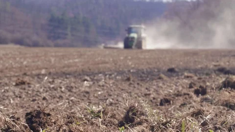 Slices and tractor plowing field to prepare it for seeding Stock Footage 126787285