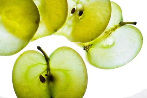 Slices of apple at the backlight isolated on a white background, macro photo Stock Photos