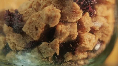 Slices of artesian bread in glass pot on bakery shop close-up. Bread with black Stock Footage 285547801