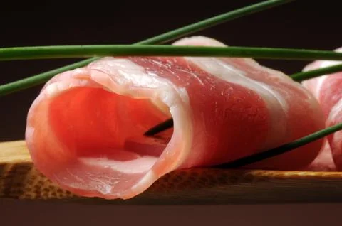 Slices of bacon on the spoon Stock Photos