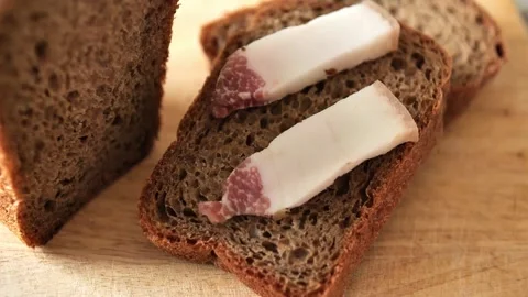 Slices of black rye bread with slices of lard. Pieces of homemade bread on a Stock Footage 244515515