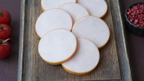 Slices of boiled chicken or pork sausage as an ingredient for home cooking. Slic Stock Footage 341482387