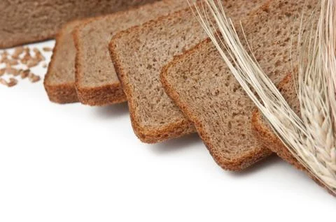 Slices  bread and ears of corn Stock Photos