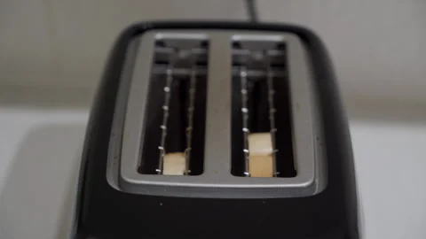 Slices of Bread Dropped In, Heating Elements Hum as Toaster Starts. Stock Footage 321526050