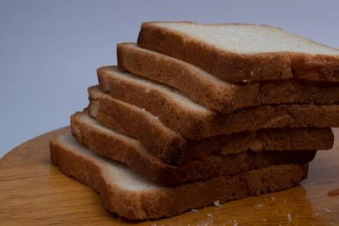 Slices of bread on grey background Stock Photos