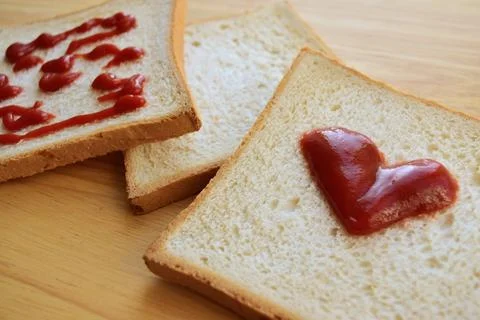 Slices of bread with ketchup Stock Photos
