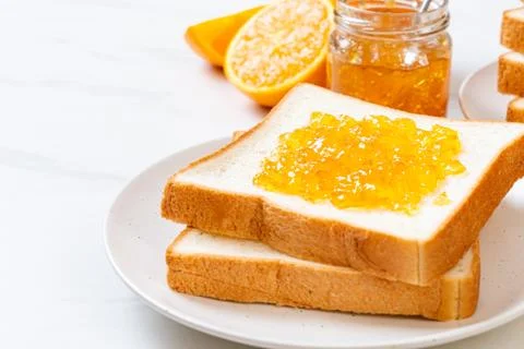 Slices of bread with orange jam Stock Photos